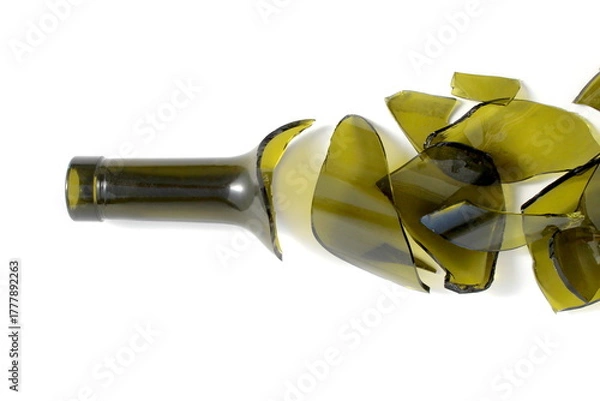 Fototapeta There is a broken green wine bottle lying on a white background.