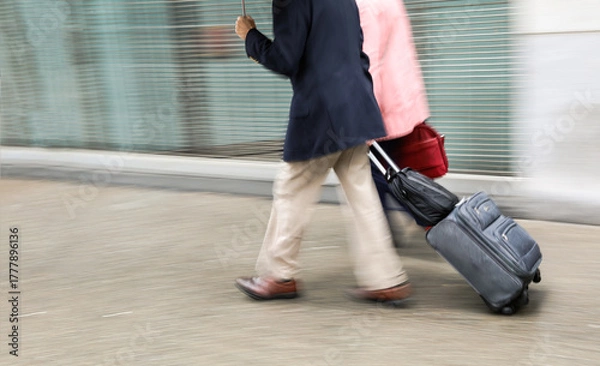 Obraz Blurred image of a man with a suitcase