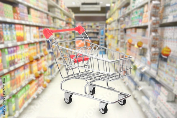 Fototapeta Empty Shopping cart on supermarket background.