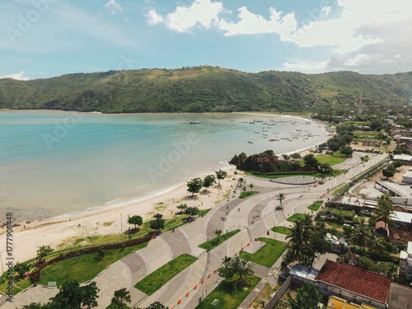 Fototapeta The coastal view is surrounded by enchanting green hills, including Merese Hill, which offers a spectacular viewpoint to enjoy the scenery. LOMBOK, NTB , INDONESIA