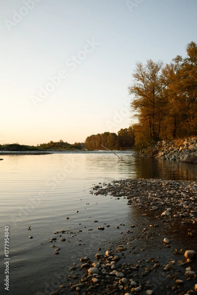 Fototapeta Calm riverbank at sunset in autumn
