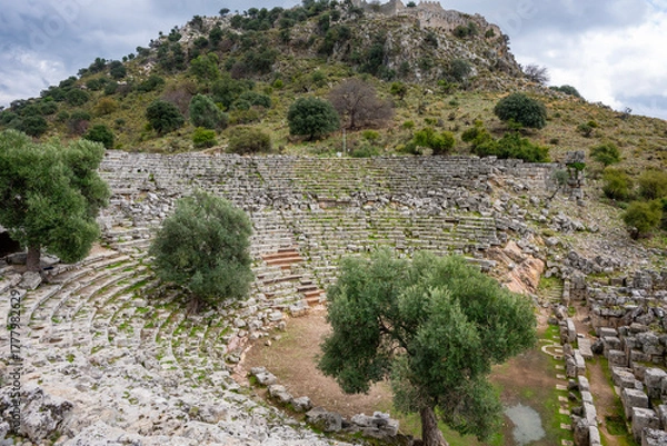 Fototapeta Kaunos (Carian: Kbid Lycian: Xbide Ancient Greek: Καῦνος; Latin: Caunus) ancient city was a city of ancient Caria and in Anatolia, a few kilometres west of the modern town of Dalyan. Amphitheatre area