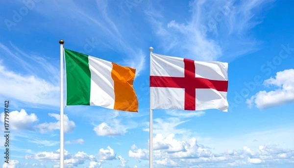 Fototapeta Two flags flying on flagpoles against a bright blue sky