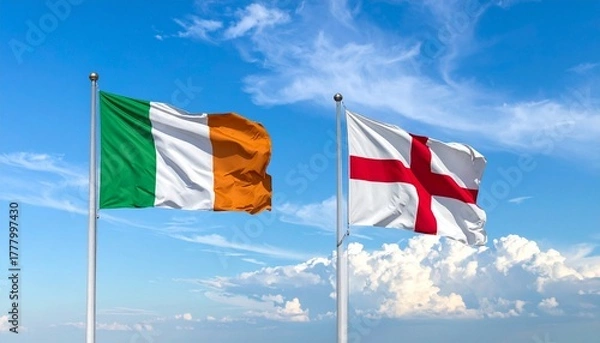Fototapeta Two flags flying on flagpoles against a bright blue sky
