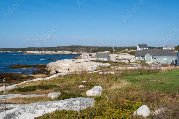 Fototapeta Peggys Cove, Canada - October 06, 2025: Picturesque fishing village on Nova Scotia’s coast, where colorful houses and boats reflect the charm of authentic maritime life.