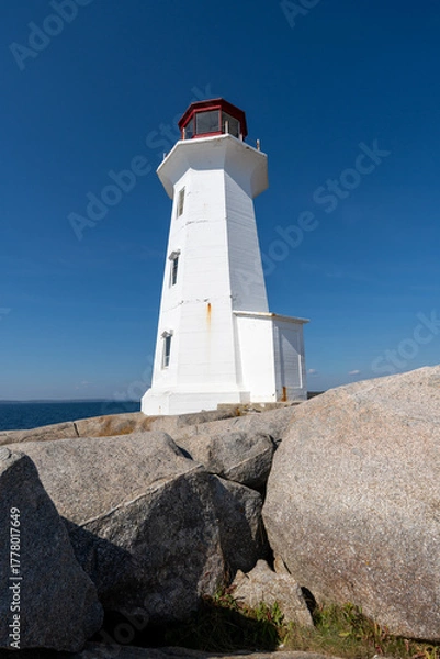 Fototapeta Peggys Cove, Canada - October 06, 2025: Peggys Point Lighthouse, also known as Peggys Cove Lighthouse, is an active lighthouse and an iconic Canadian image.