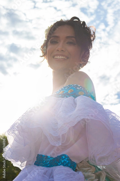 Obraz Portrait of a smiling Colombian dancer in a traditional dress in Neiva, Huila, Colombia. Concept of Colombian culture and happiness