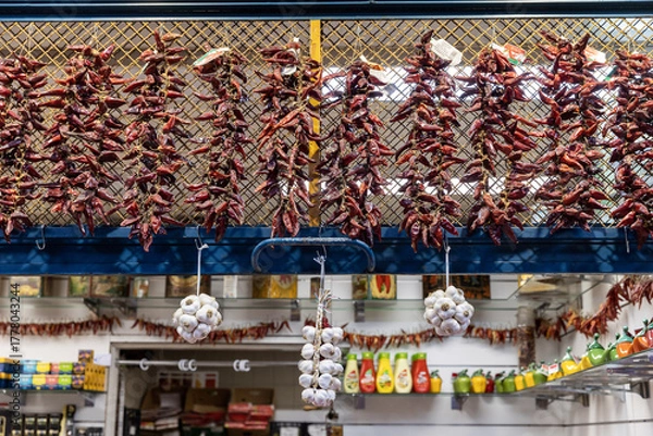Fototapeta Hungary. Budapest. Chili peppers hanging in a shop at the market.