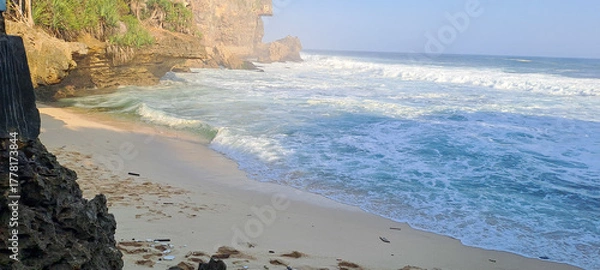 Fototapeta Waves crashing down on the beach	