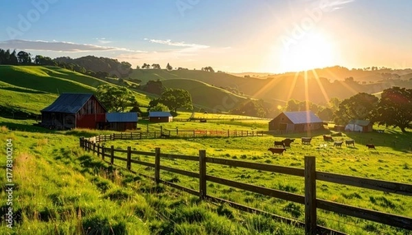 Obraz Golden Hour Sunrise Over Rolling Hills Farm Landscape with Rustic Barns and Grazing Cattle