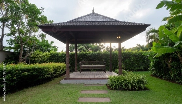 Obraz A peaceful wooden gazebo stands gracefully in a lush garden surrounded by vibrant greenery, offering a tranquil outdoor space for rest, reflection, and connection with nature under the open sky