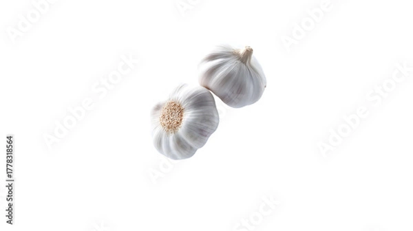 Fototapeta A peeled garlic piece floats elegantly with soft lighting, isolated on white