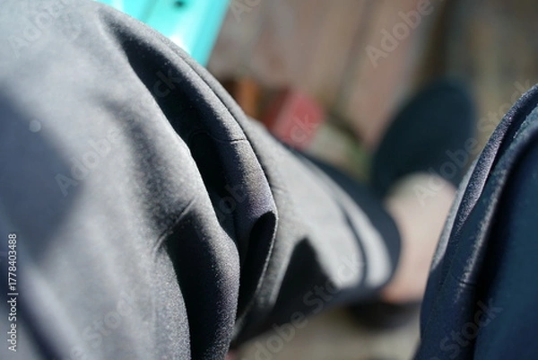 Fototapeta Legs wearing long black pants and black shoes with blurred background