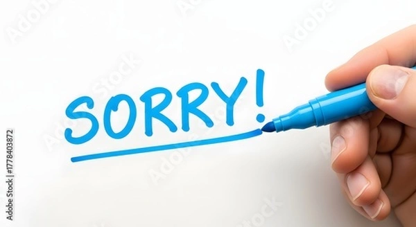 Fototapeta Hand writing sorry with a blue marker on a white surface