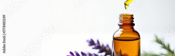 Obraz Lavender-based skincare oil presented in amber glass bottle. Modern apothecary theme with fresh green tones, reflecting balance between nature, science, and self-care.