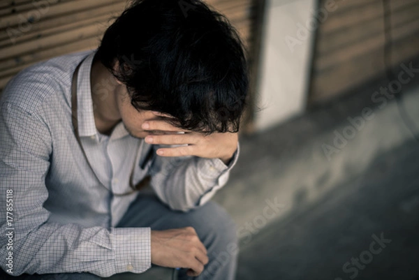 Obraz business man is stressed from his work. depression and anxiety concept.