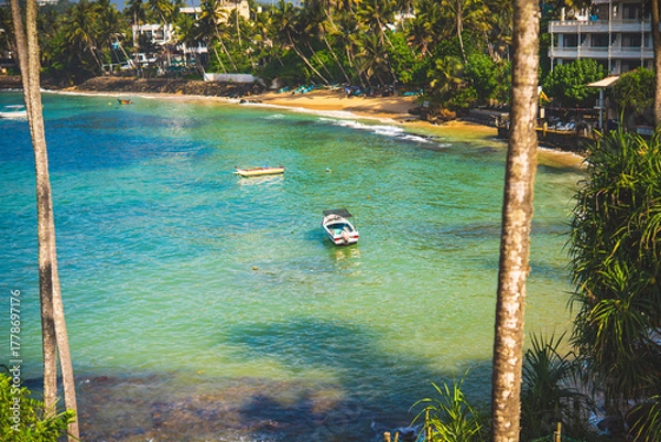 Obraz Turquoise lagoon with palm trees, boats and beach resorts in Sri Lanka