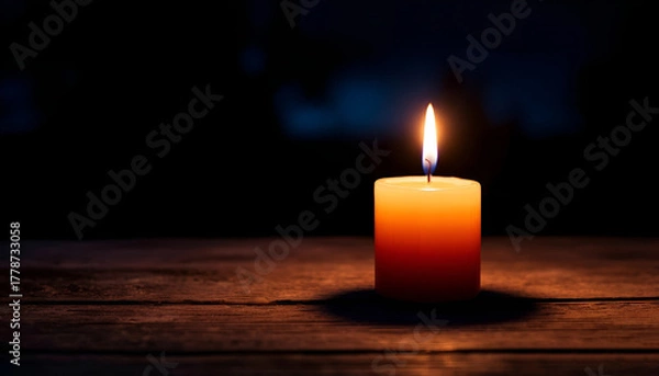 Fototapeta burning candle on a dark background