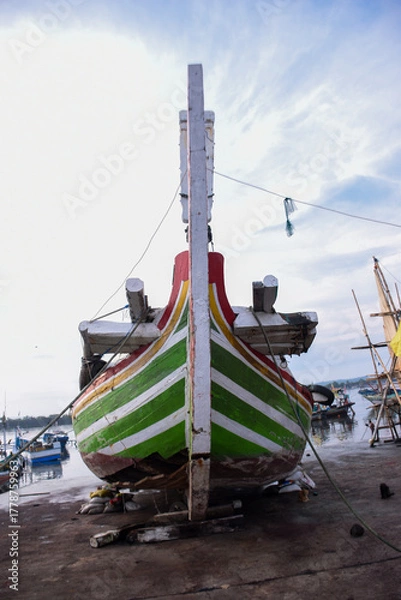 Fototapeta The bow of a fishing boat being repaired at the harbor.