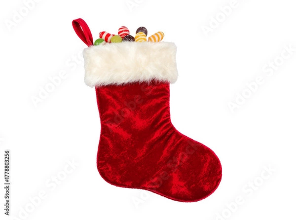 Obraz Classic red Christmas stocking with white fluffy trim and candy peeking out, isolated on white PNG background.