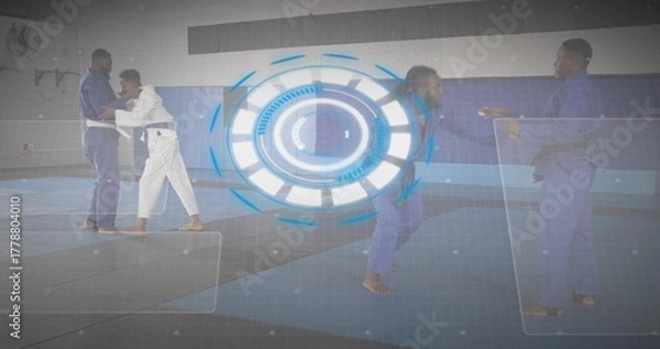 Fototapeta Practicing grappling martial arts fighters wearing gis on mats in dojo, with digital overlays