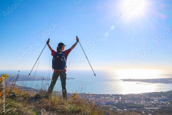 Obraz young girl with a backpack is hiking alone in nature