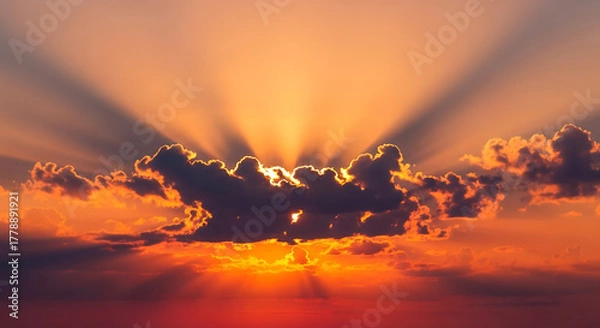 Obraz Golden sun rays shining through clouds at sunset in the sky view