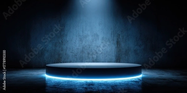 Obraz Illuminated round podium with blue neon light in dark room with concrete wall and floor for product presentation