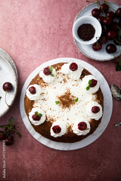 Fototapeta Chocolate cake with whipped cream and cherries