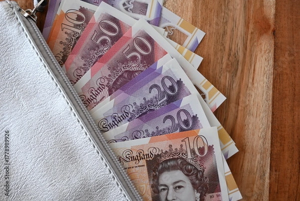 Obraz Black partmone with british pound money. United Kindom bills in leather wallet for commerce concept.