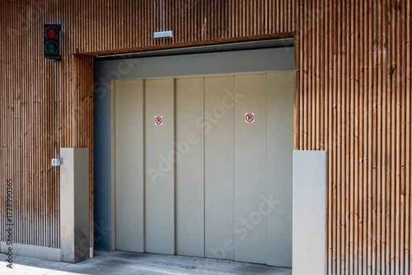 Obraz Garage entrance door in parking part of the building with sign.