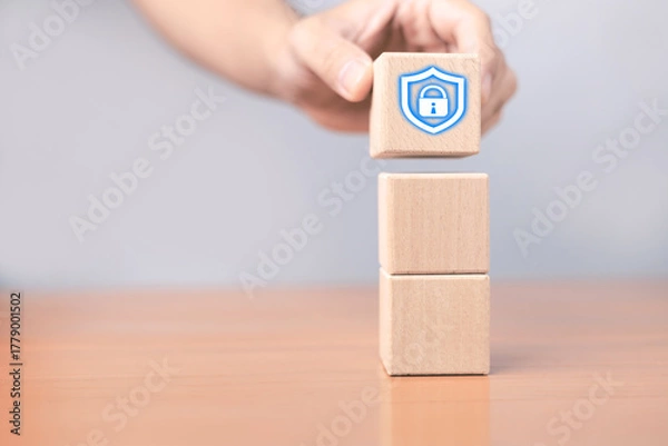 Fototapeta A wooden block with a security lock icon represents the concept of data protection, privacy and cybersecurity, demonstrating the creation of a strong security foundation for digital information.