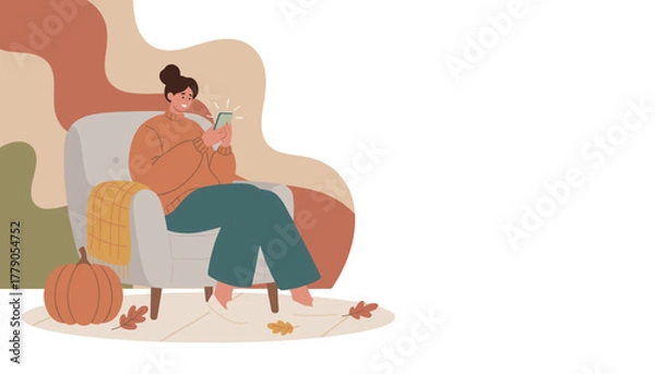 Obraz Cozy autumn relaxation Woman sitting in armchair smiling while using her smartphone