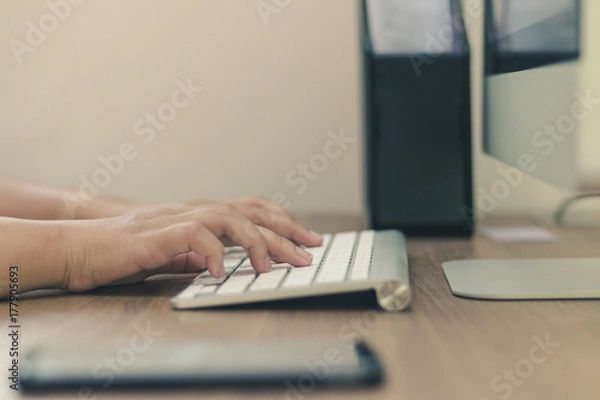 Fototapeta Close up beside hand typing on the keyboard