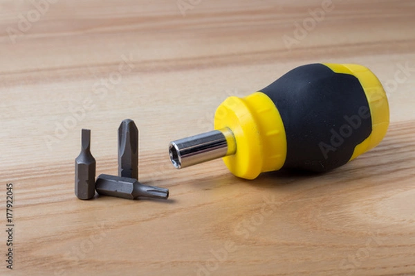 Obraz Screwdriver with three bits on wooden table
