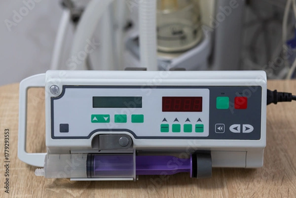 Fototapeta A syringe infusion pump is on the table. Against the background of medical equipment.