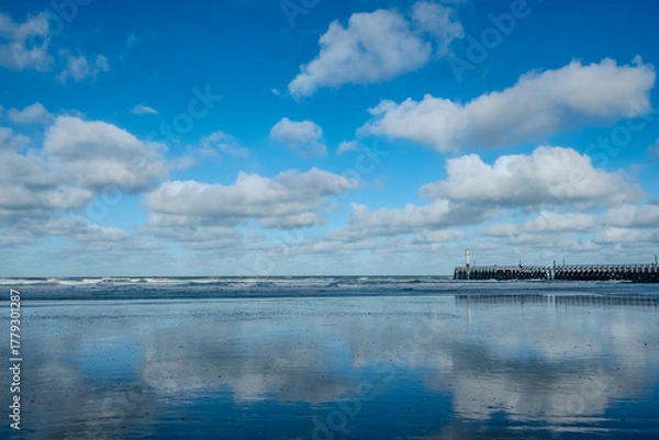 Fototapeta Peaceful surface shows perfect symmetry and calmness, Quiet waters reflect sky and distant pier in balanced harmony