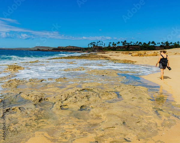 Fototapeta Female Tourist Walking on Sand and Coral Reef on Kepuhi Beach, Molokai, Hawaii, USA