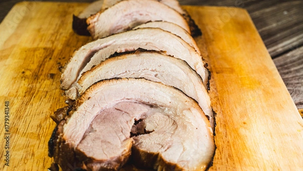 Obraz Sliced rolled pork belly chashu arranged on a wooden board, ready for ramen. Tender, marinated, and perfectly cooked. Ideal for Asian cuisine and food presentation.