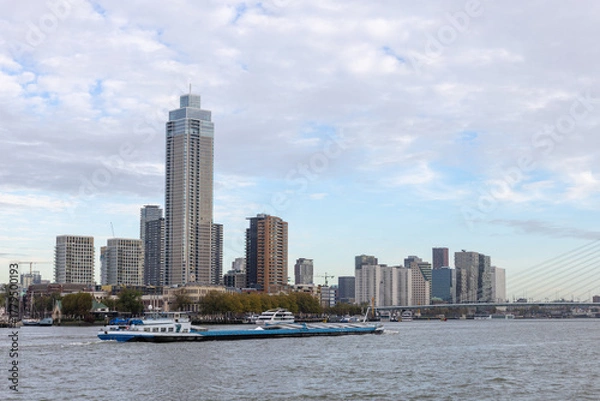 Obraz Sailing cargo ship with the Rotterdam skyline and the Erasmus Bridge in the background