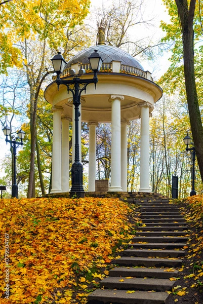 Obraz An ancient rotunda, staircase, and lantern in a city park in autumn