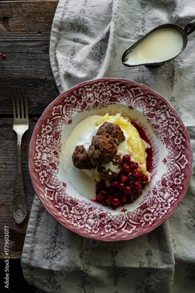 Fototapeta Traditional Swedish meatballs with mashed potatoes, cranberries and creamy gravy in vintage plate on wooden table. Homemade dinner. Comfort food.