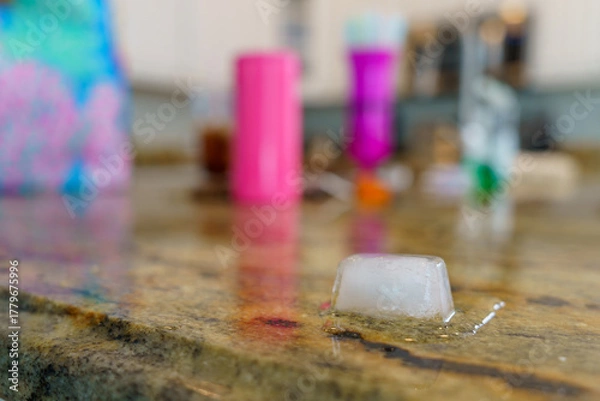 Fototapeta Melting Ice Cube on Granite Counter in Holmes Beach