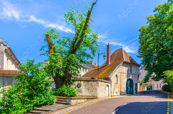 Fototapeta Road street leading up in Besancon old town centre ville, La boucle de Besançon city historic centre with medieval buildings in sunny summer day, Bourgogne-Franche-Comte region, France