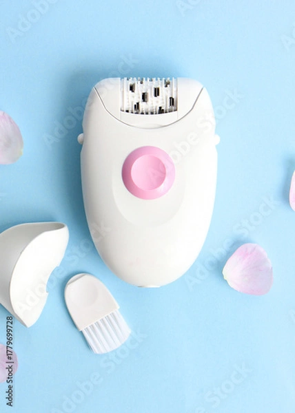 Fototapeta Modern mechanical epilator on a colored background close-up.. Vertical photo format