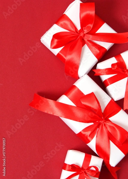Fototapeta Set of beautifully wrapped gift boxes on a colored background top view.. Vertical photo format