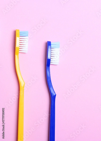 Fototapeta Toothbrushes on a colored background top view. Oral hygiene.. Vertical photo format