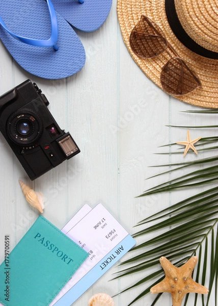 Fototapeta travel accessories and tropical leaves on a colored background top view.. Vertical photo format