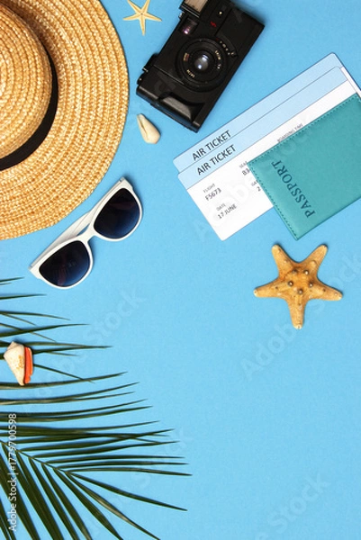 Fototapeta travel accessories and tropical leaves on a colored background top view.. Vertical photo format