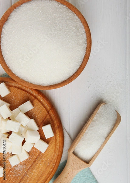 Fototapeta white sugar on the table on a light background close-up. Vertical photo format